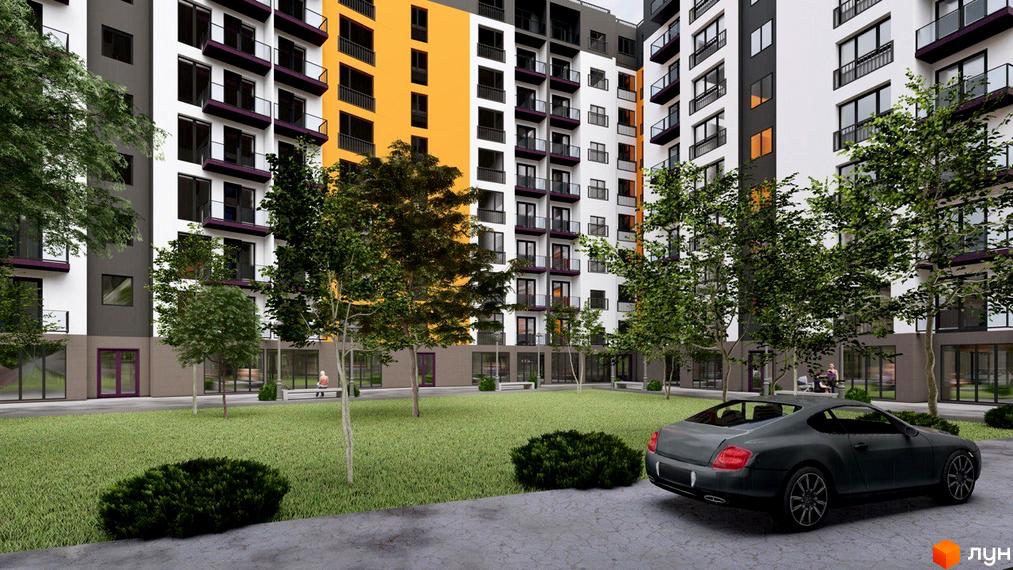 Житловий комплекс Лазенський Дім з яскравим фасадом та озелененою прибудинковою територією, де розташований автомобіль.