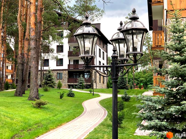 Житловий комплекс DESNA residence з багатоповерховими будинками та доглянутою прибудинковою територією з доріжками та зеленими насадженнями.