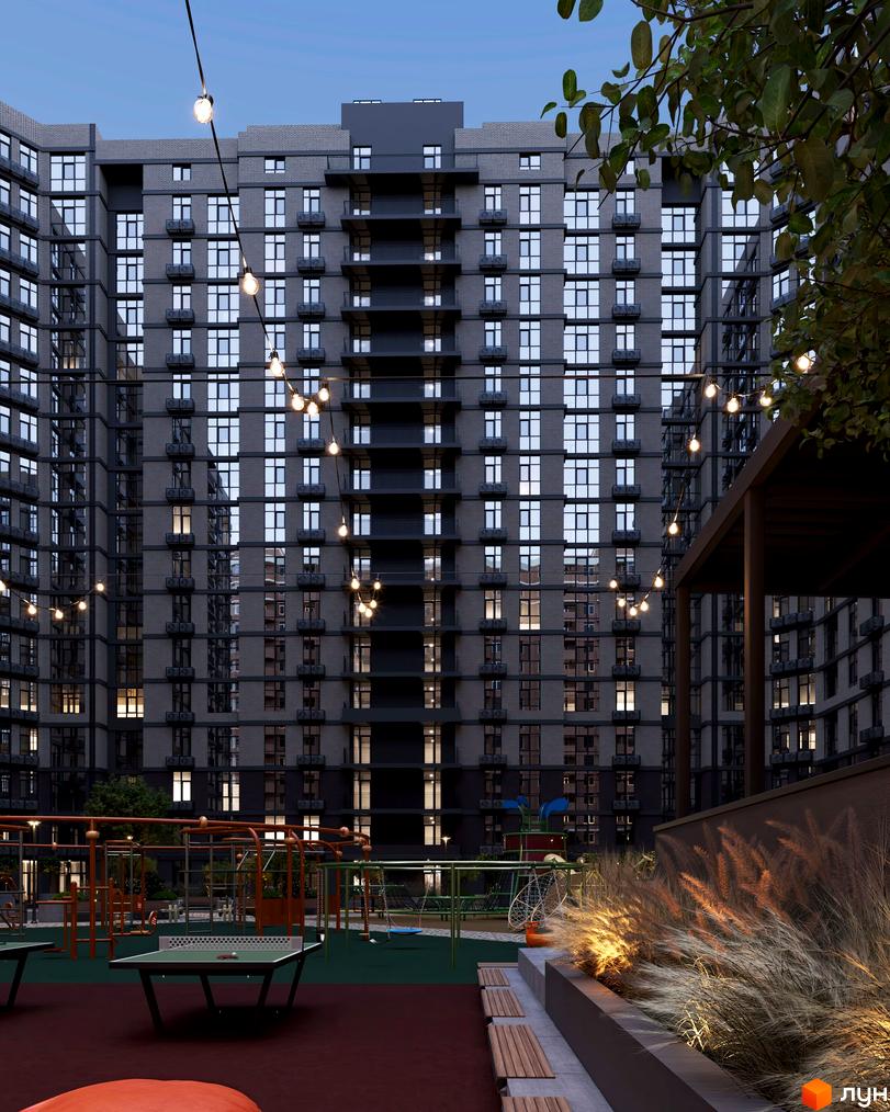 Житловий комплекс Real Park Nova з фасадами з сірої цегли та балконами, освітлений гірляндами, з дитячим майданчиком та зоною відпочинку.