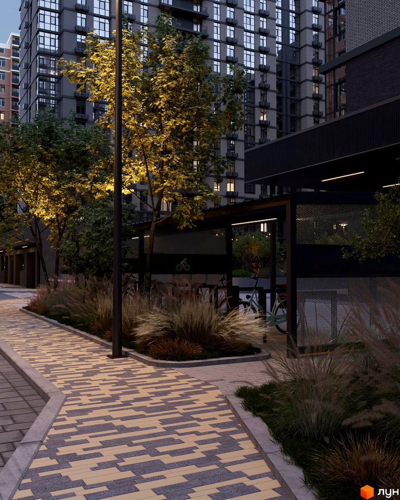 Житловий комплекс Real Park Nova: багатоповерхові будинки з темним фасадом, освітлена прибудинкова територія з доріжками та деревами.