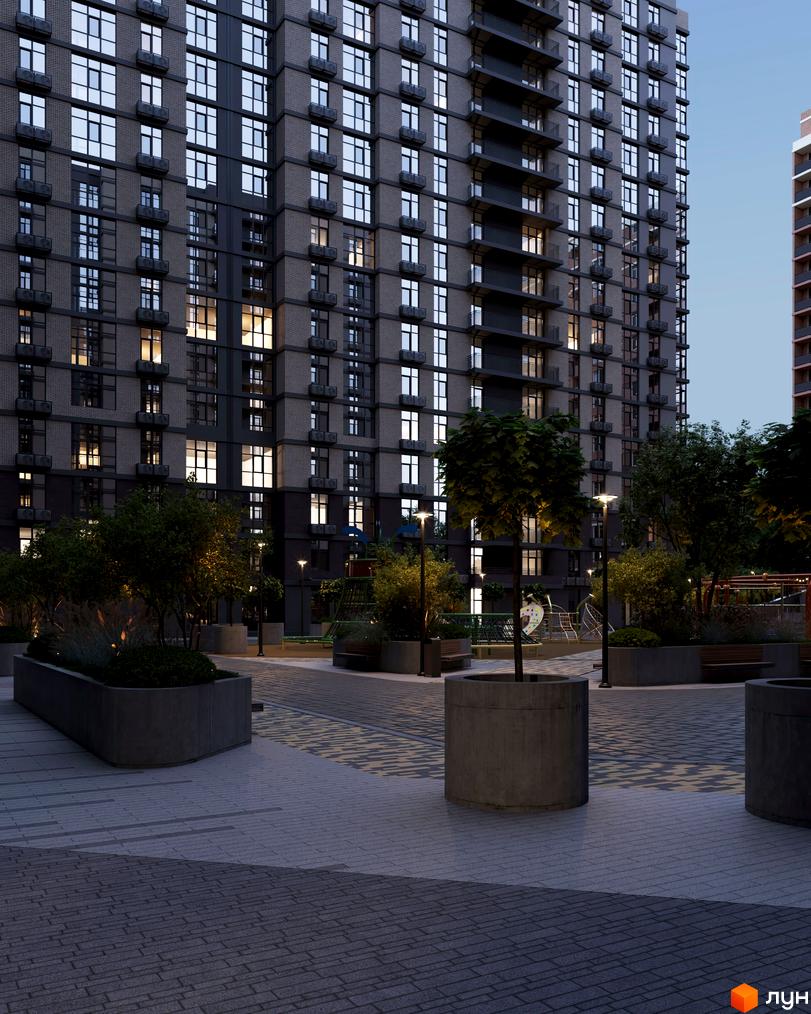 Житловий комплекс Real Park Nova: багатоповерховий будинок з темним фасадом та освітленими вікнами. У дворі є доріжки, дерева та ліхтарі.