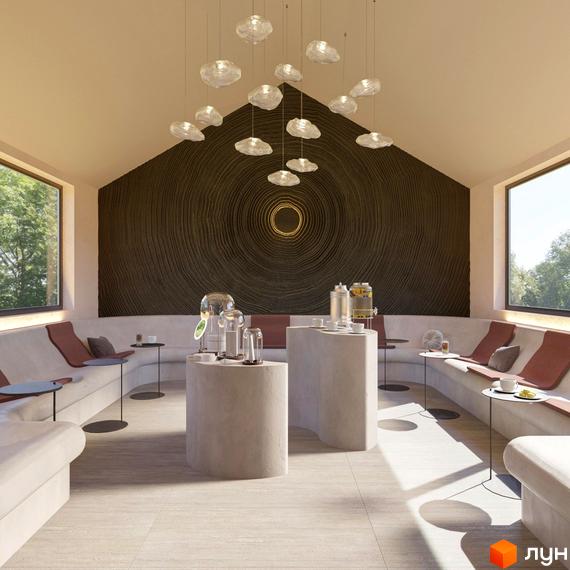 Інтер'єр зони відпочинку в житловому комплексі КМ Елізіум resort з диванами, столиками та декоративною стіною.