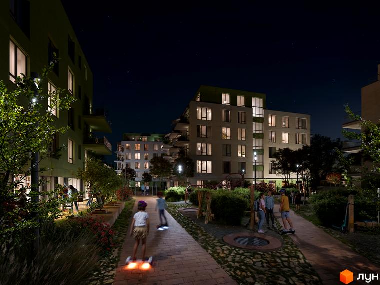 Житловий комплекс Residence City вночі з освітленими вікнами та дитячим майданчиком. Сучасна архітектура та зелена прибудинкова територія.