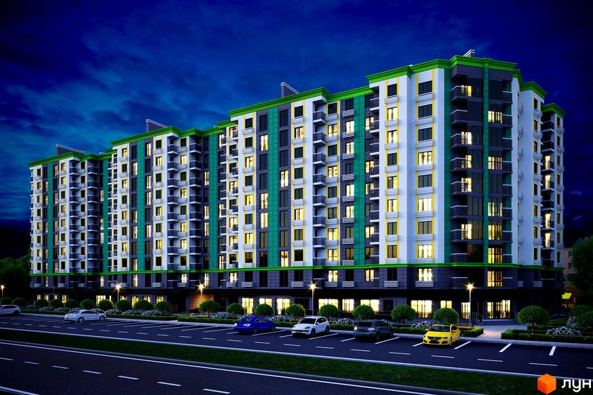 Житловий комплекс Comfort City вночі: багатоповерховий будинок з біло-зеленим фасадом та освітленими вікнами, перед ним парковка з автомобілями та доглянута територія.