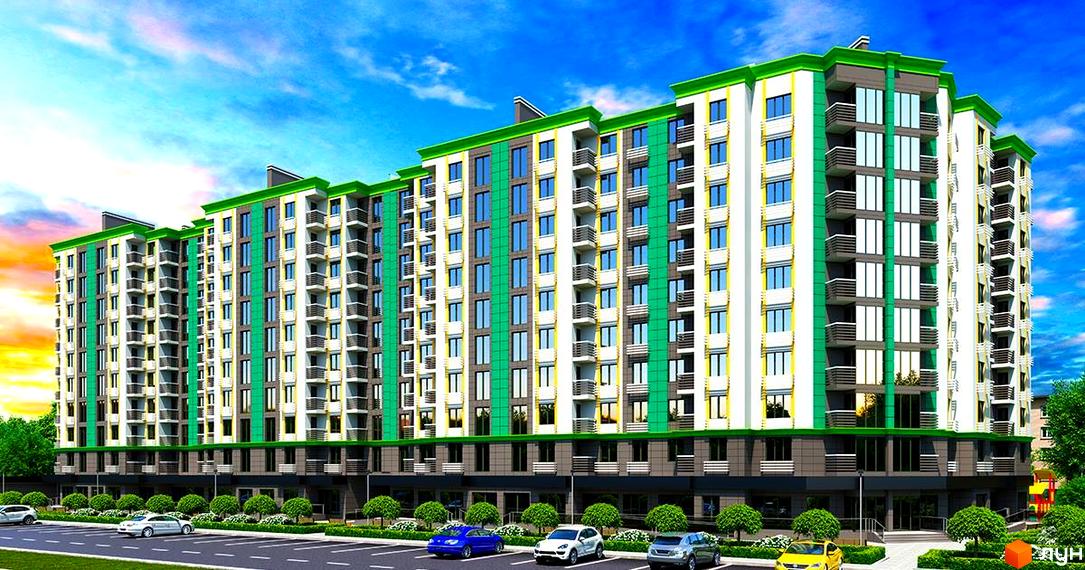 Житловий комплекс Comfort City. Фасад багатоповерхового будинку має білі, зелені та сірі секції, багато вікон та балконів, а також прибудинковий паркінг.
