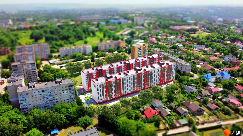 Житловий комплекс Smart Fort: вид зверху на кілька білих багатоповерхових будівель з червоними фасадами, розташованих серед дерев та інших будинків.