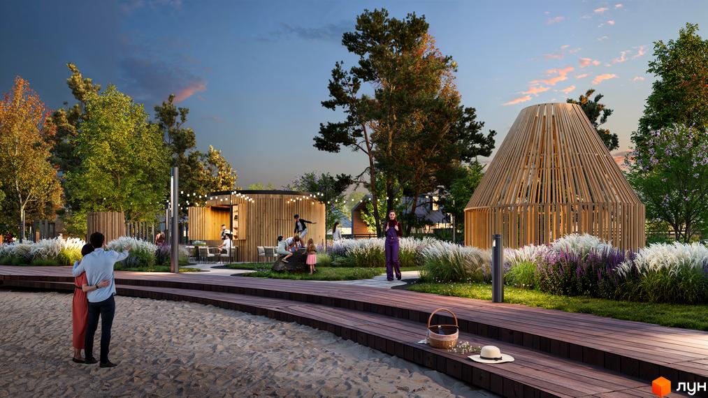 Котеджне містечко КМ Piemont eco village з дерев'яними альтанками та зонами відпочинку біля піщаного пляжу. На території висаджені декоративні рослини та дерева.