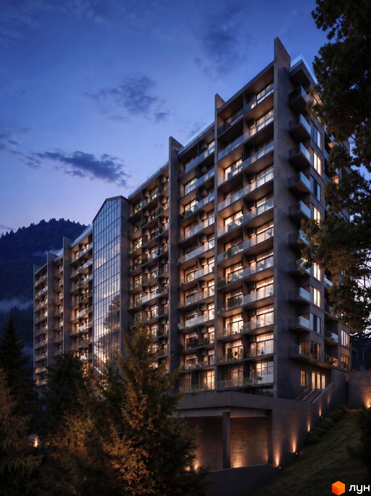 Багатоквартирний будинок AMA APARTMENTS з темним фасадом, великим скляним центральним елементом та балконами, освітлений ввечері, серед дерев.