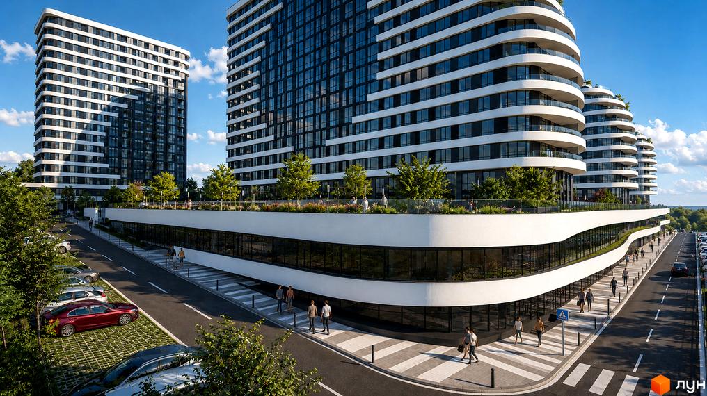 Сучасний житловий комплекс SvitLand Residences з багатоповерховими будинками та вигнутими балконами. Територія навколо новобудови облаштована парковкою та пішохідними доріжками.