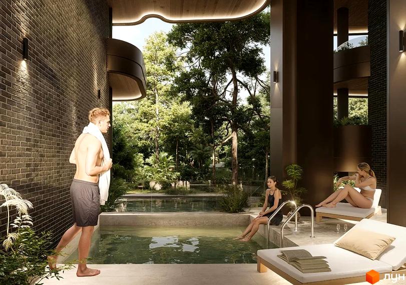 Onsen: зона відпочинку з басейном та лежаками на тлі зелені. Сучасна архітектура комплексу з цегляною стіною та дерев'яними елементами.