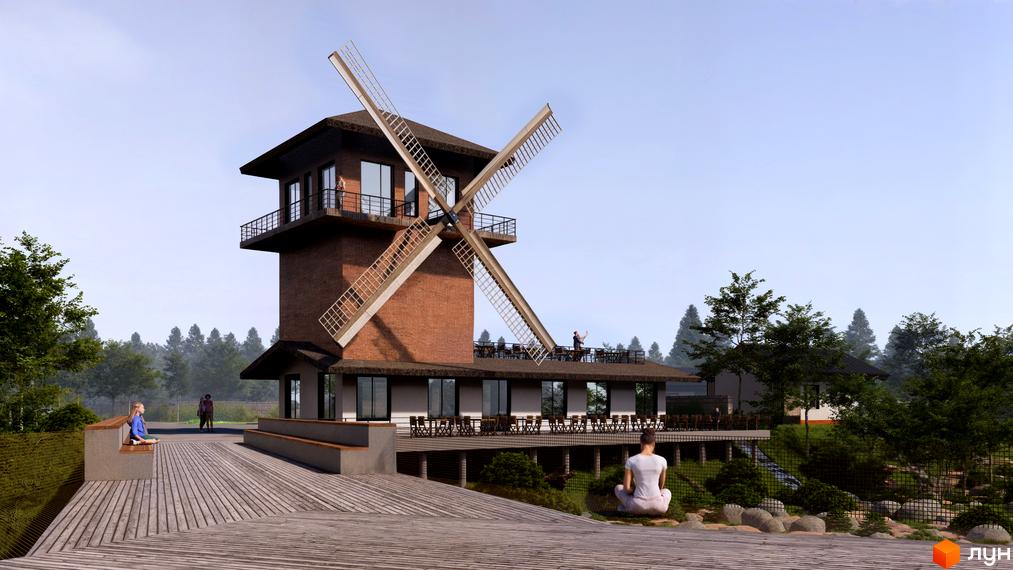 Котеджне містечко ПАВЗА Village and Spa: будівля з червоної цегли у формі млина з лопатями, оточена дерев'яною терасою та зеленню.