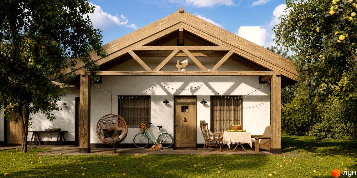 Котеджне містечко КМ PAWZA Village and Spa з дерев'яною верандою та яблуками на деревах, оточений зеленою травою.