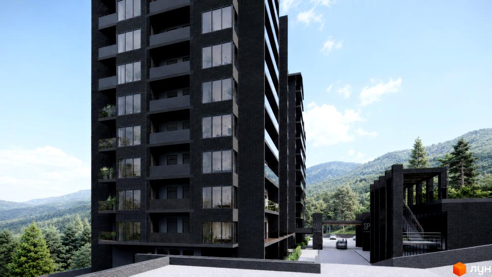 Фасад багатоповерхового житлового комплексу AMA APARTMENTS виконаний у темних тонах з балконами та скляними поручнями. Навколо розташовані гори, вкриті лісом, та в'їзна група.