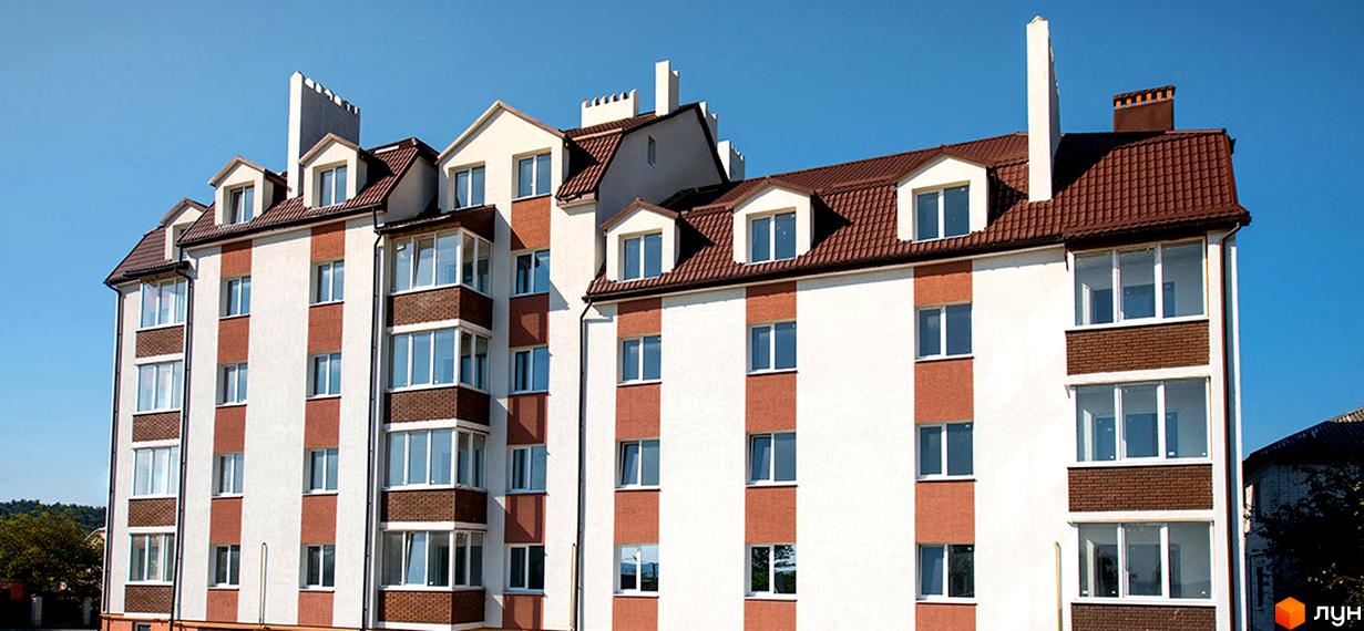 Фасад новобудови на вул. Коцюбинського, 1 з білими та коричневими вертикальними смугами та коричневим дахом. Будинок має багато вікон та балконів.