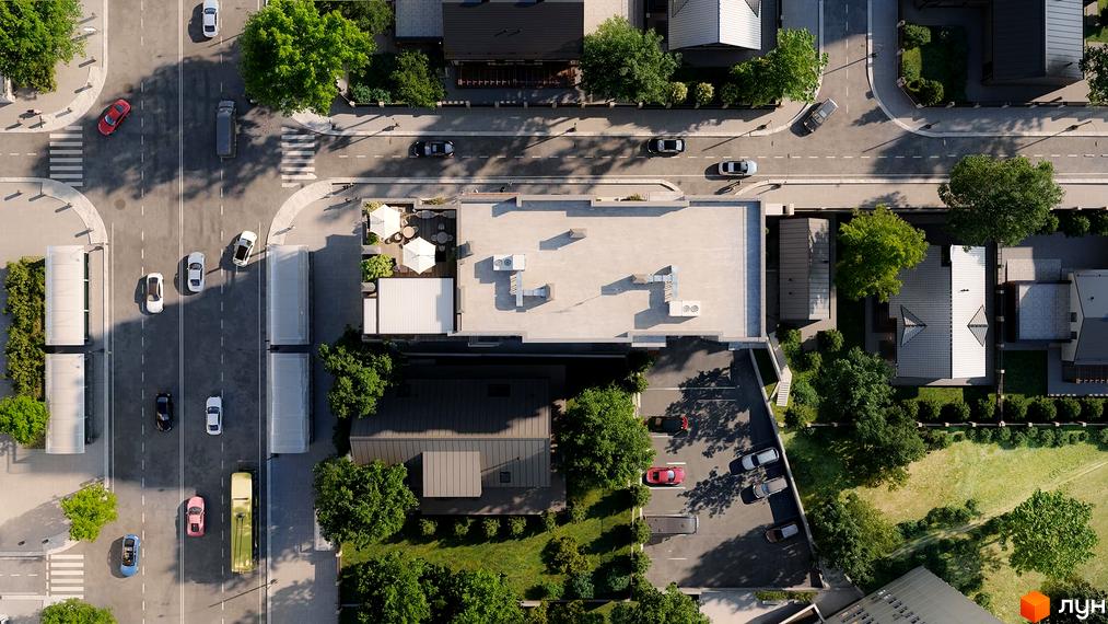 Апарт-готель THE ROOF. Вид зверху на будівлю з пласким дахом та прибудинкову територію з деревами та дорогою.