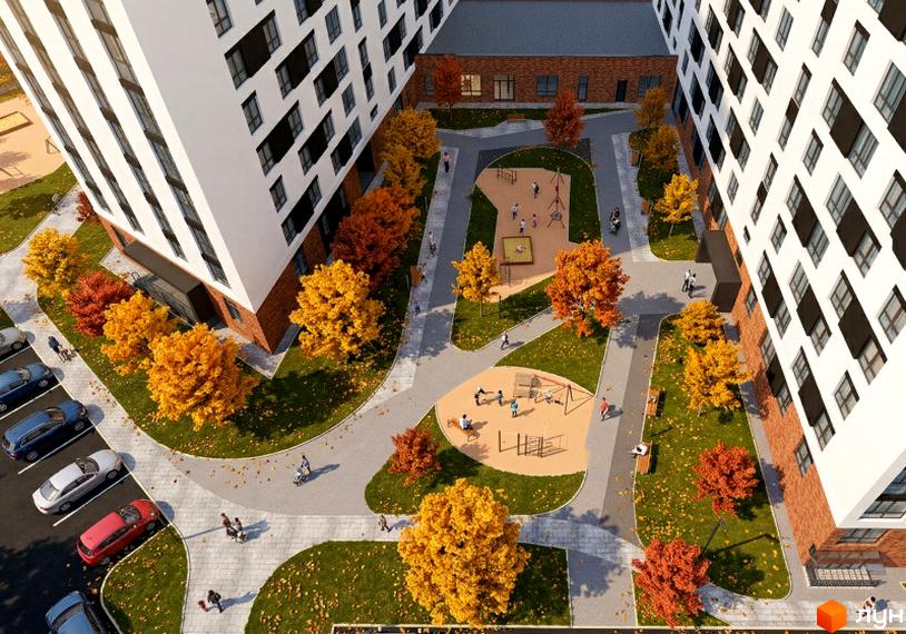 Житловий комплекс Yuvi city з багатоповерховими будинками, білими фасадами та цегляною основою. Внутрішній двір має дитячі майданчики, зелені газони та осінні дерева.