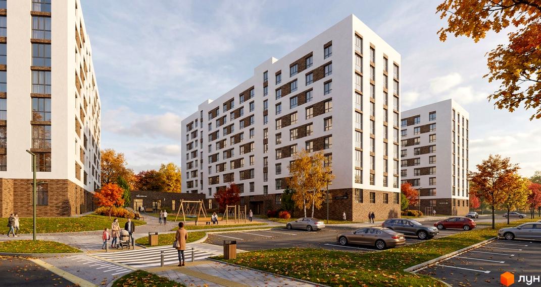 Житловий комплекс Yuvi city: багатоповерхові будинки з білим фасадом та коричневими вставками, оточені зеленими газонами, осінніми деревами та дитячим майданчиком.