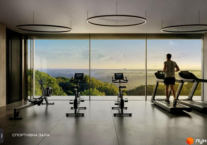 Спортивна зала в Lion Hills Villas з тренажерами та панорамними вікнами, що виходять на мальовничий краєвид.