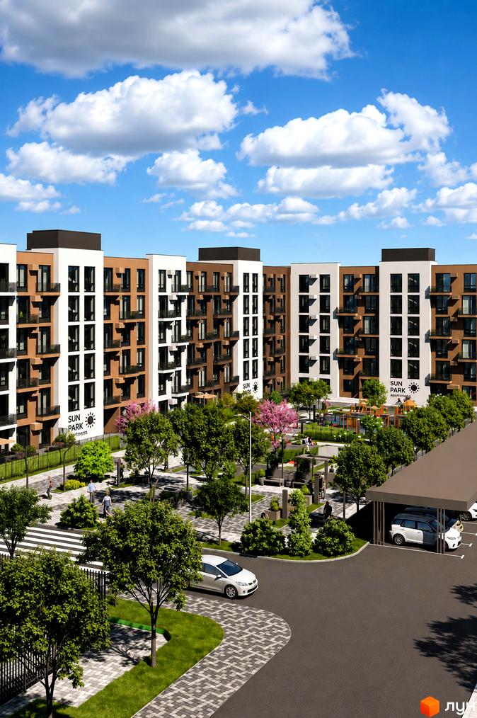 Житловий комплекс Sun Park 2 з багатоповерховими будинками біло-коричневого кольору. Прибудинкова територія озеленена, є дитячий майданчик та паркінг.