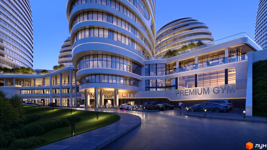 БФК INTERGAL CITY з вигнутими фасадами та підсвіткою, прибудинкова територія з газоном та автомобілями.