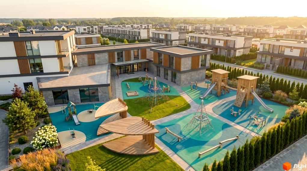 Котеджне містечко Montana City: фасади будинків з сірого каменю та білої штукатурки, дитячий майданчик з гірками та пісочницею.