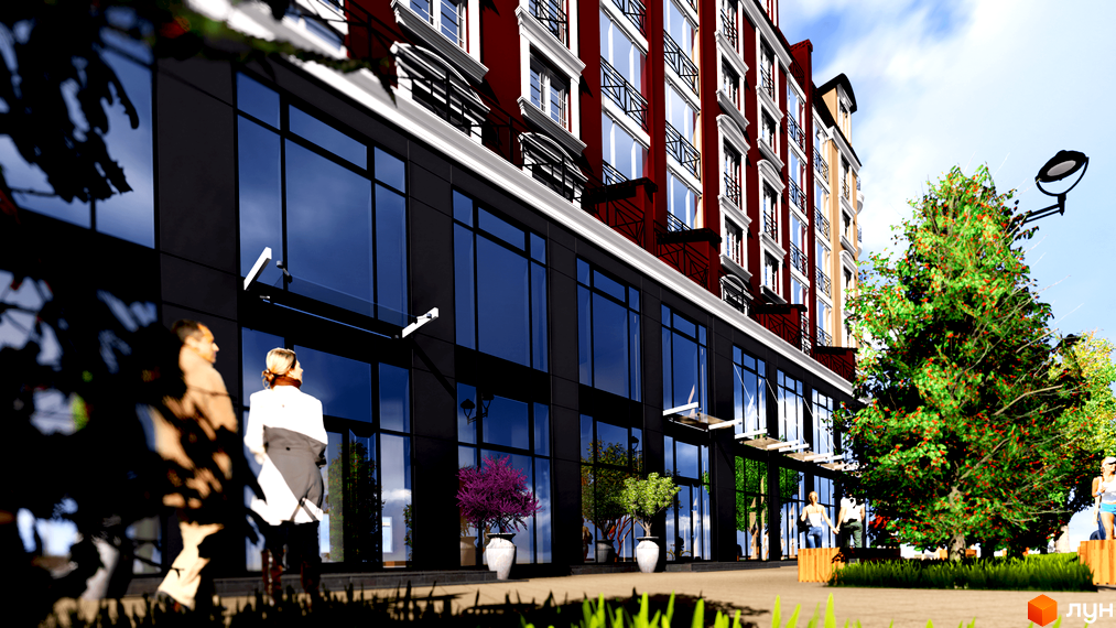 Житловий комплекс Агора з червоним фасадом, білими вікнами та великими скляними вітринами на першому поверсі. Навколо будинку зелені насадження, дерева та пішохідна зона.