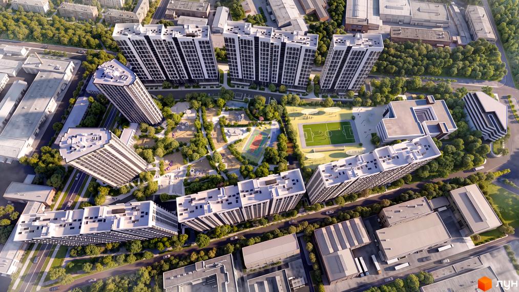 Високі чорно-білі будинки ЖК Star City з упорядкованим зеленим двором та спортивними майданчиками.
