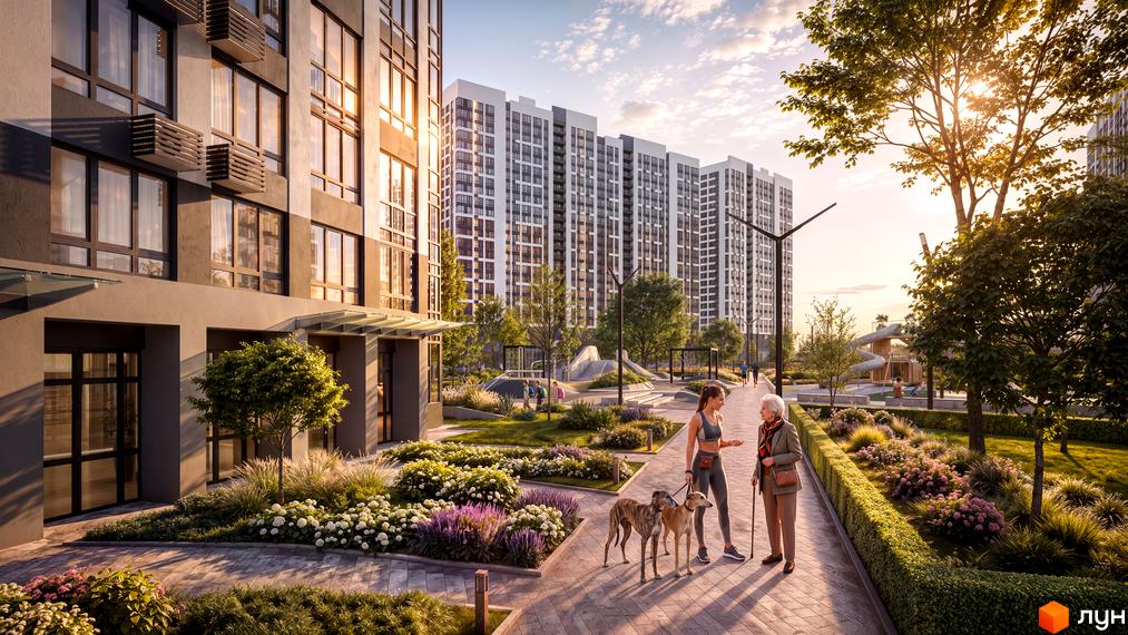 Багатоквартирний будинок ЖК Star City з панорамними вікнами та впорядкована прибудинкова територія з прогулянковою алеєю і клумбами.