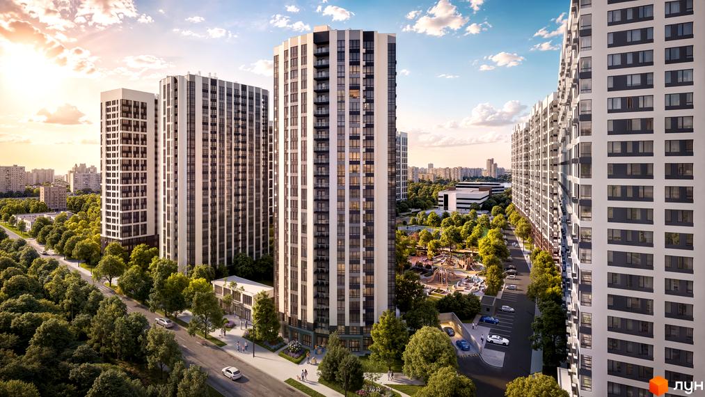 Багатоповерхові будинки ЖК Star City з балконами та велика зелена прибудинкова територія з дитячим майданчиком.
