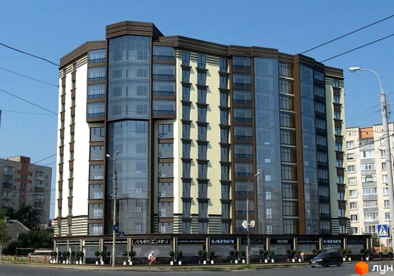 Житловий комплекс Атлант: багатоповерхова будівля зі світлими фасадами, великими вікнами та комерційними приміщеннями на першому поверсі. Розташований біля дороги.