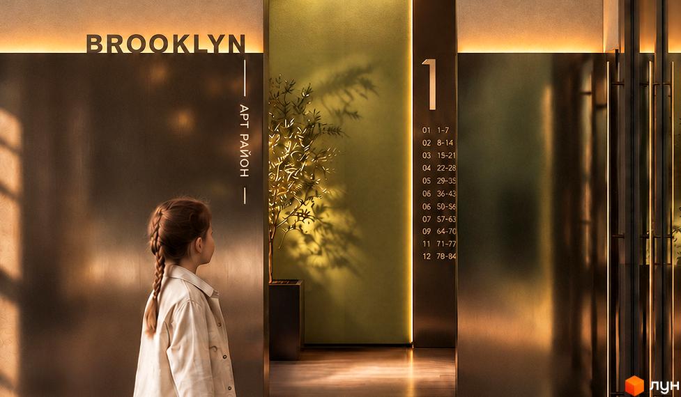 Дитина дивиться на металеві панелі ліфтового холу новобудови Brooklyn з нумерацією поверхів та підсвічуванням.