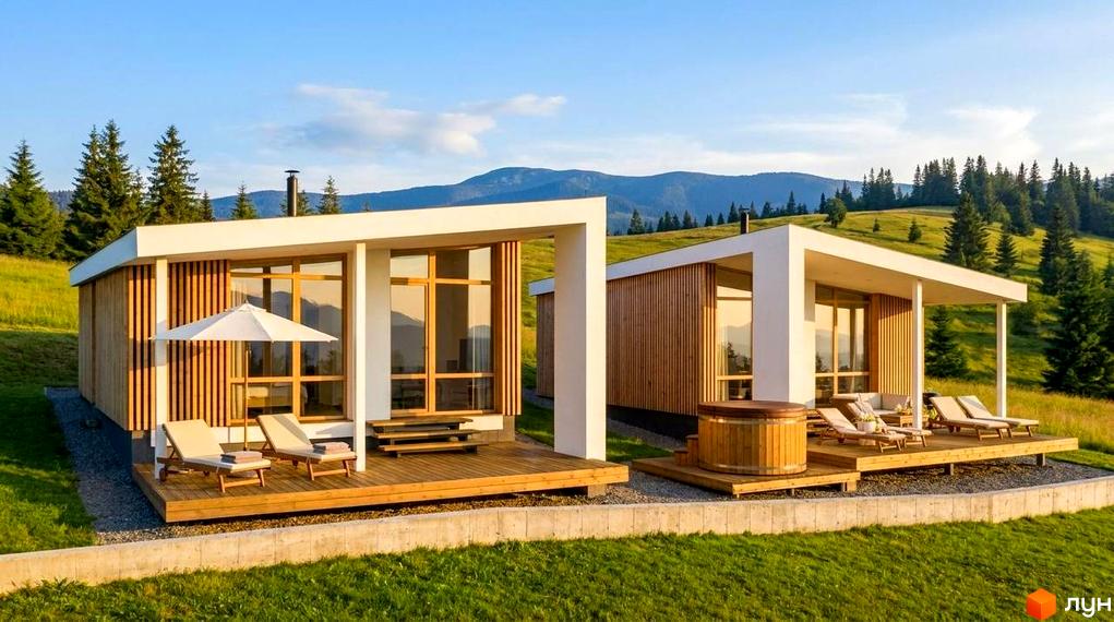 Сучасний котедж у КМ YAKO Villas з панорамними вікнами, дерев'яною терасою та лежаками на тлі гір.