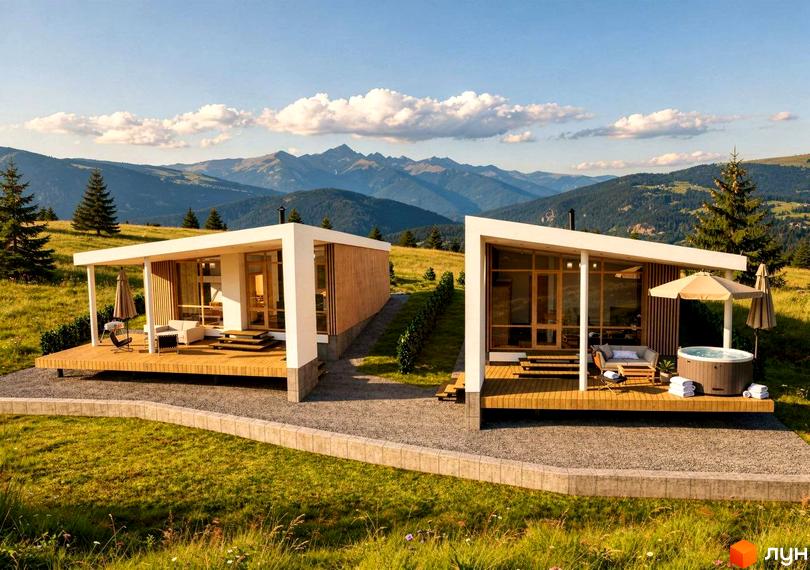 Котеджне містечко YAKO Villas з панорамними вікнами та дерев'яними терасними майданчиками з меблями на тлі гір.