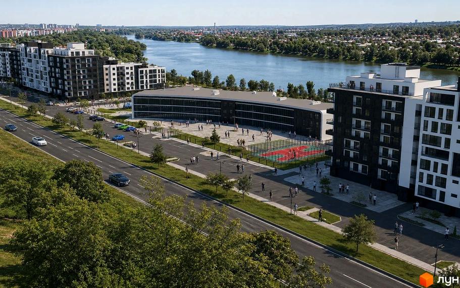 Житловий комплекс River Park з чорно-білими фасадами, облаштованим двором, спортивним майданчиком і парковкою поряд з річкою.