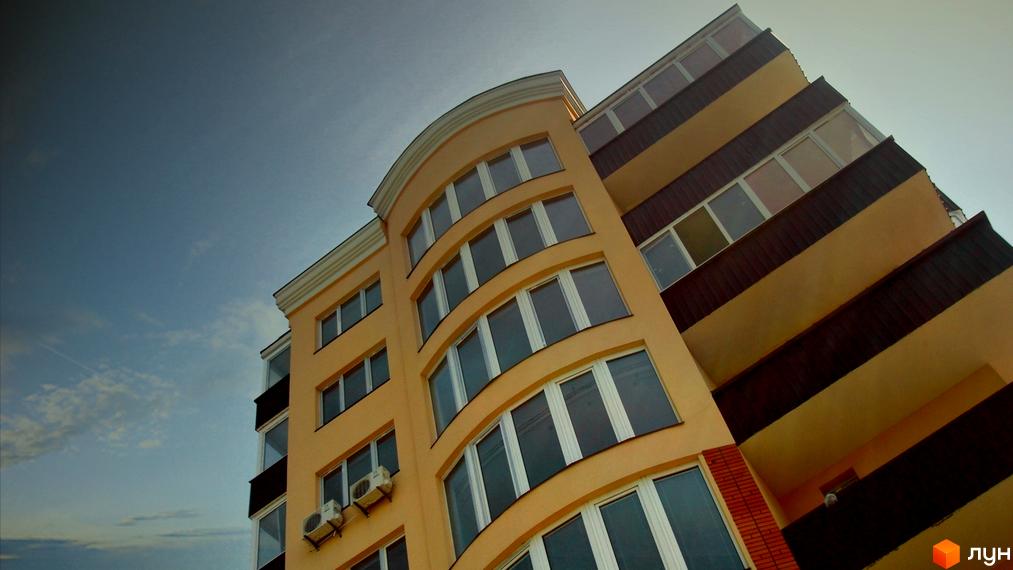 Фасад новобудови на вул. Івана Мазепи (Пушкінська), 11, з великою кількістю вікон та балконів під блакитним небом.