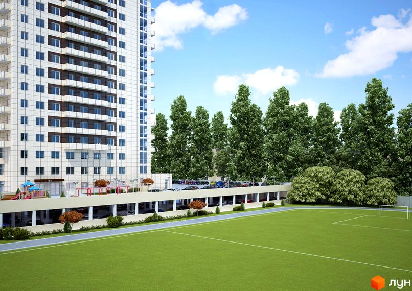 Зовнішній вигляд ЖК Панорама на Виставці: висотна біла будівля з балконами та паркінг. Поруч зелені дерева та футбольне поле.