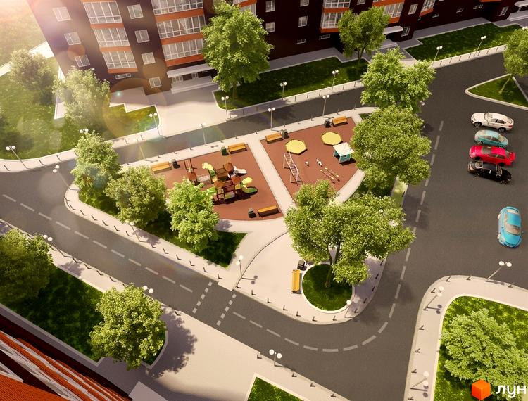 Житловий комплекс Ріверсайд: вид зверху на багатоповерховий будинок з фасадом з цегли та вікнами, дитячий майданчик та паркування з автомобілями.