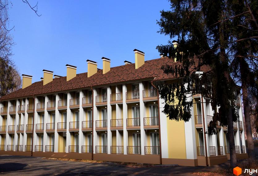 Житловий комплекс Мрія – триповерхова новобудова з коричневим дахом та балконами. Фасад будинку світло-жовтий з білими колонами. Навколо будинку дерева.