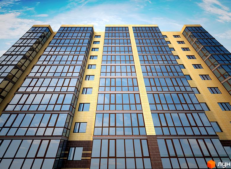 Зовнішній вигляд будинку Житлового комплексу Сімейний в Кам'янець-Подільському. Багатоповерхова будівля з великими вікнами.