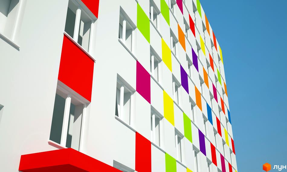 Фасад житлового комплексу Бестужевські сади з яскравими кольоровими квадратами на білому фоні. Вікна розташовані рівними рядами, створюючи ритмічний візерунок.