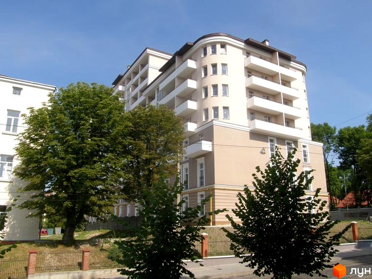 Зовнішній вигляд будинку на вул. Мечникова, 16а. Багатоповерхова будівля з балконами, оточена зеленими насадженнями.