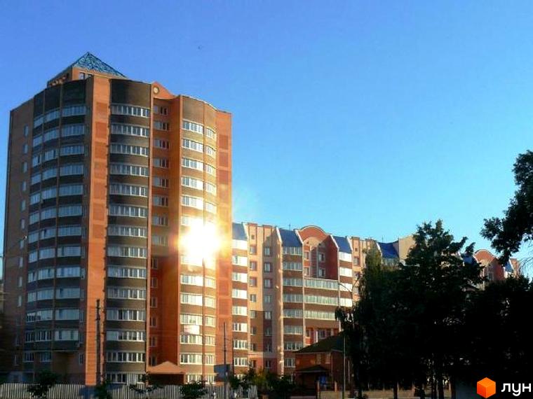 Зовнішній вигляд житлового комплексу на вул. Леваневського, 70. Багатоповерховий будинок з цегляним фасадом та великою кількістю вікон. Навколо будинку зелені насадження.