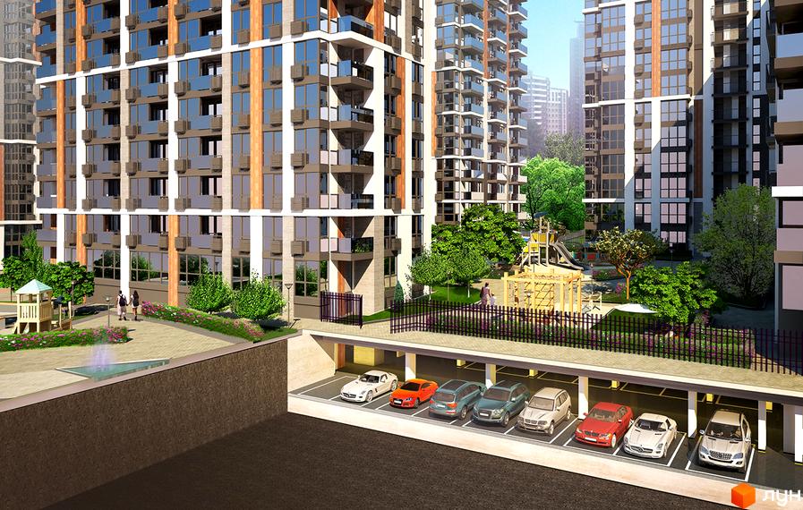 Житловий комплекс Французький квартал 2. Фасад будинку з панорамними вікнами та балконами. На прибудинковій території дитячий майданчик та паркінг з автомобілями.