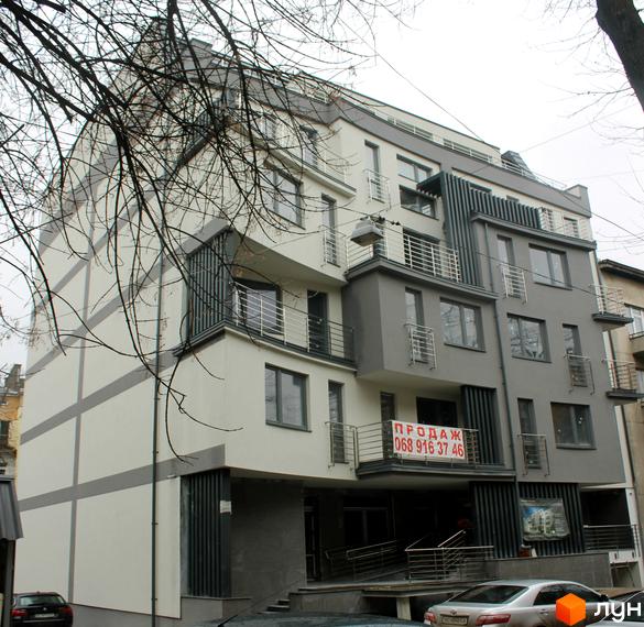 Будинок житлового комплексу на вулиці Глибока, 9-11. Фасад будівлі оздоблений білими та сірими елементами, з балконами та великими вікнами. Біля будинку розташовані автомобілі та вхідна група.