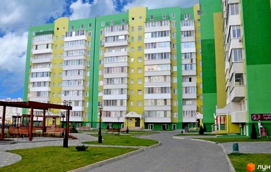 Житловий комплекс ЖМ Острови з яскравим фасадом, прибудинкова територія з зеленими насадженнями та зонами для відпочинку.