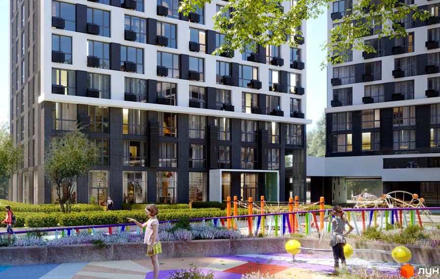 Житловий комплекс Славутич 2.0: фасади будинків з великою кількістю вікон та кондиціонерів. Прибудинкова територія з дитячим майданчиком та зеленими насадженнями.