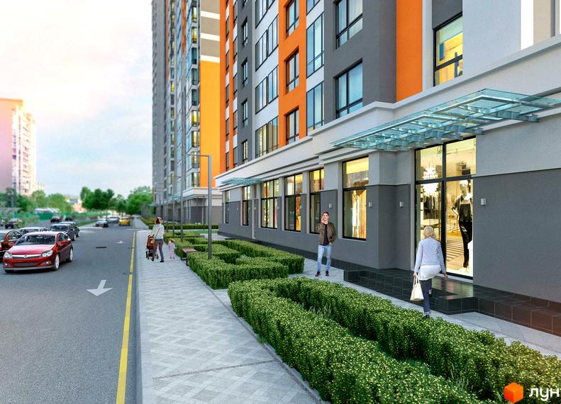 Житловий комплекс Бережанський. Зовнішній вигляд новобудови з оранжевими та сірими фасадами, скляним навісом над входом. Поруч доглянута прибудинкова територія з кущами та пішохідною доріжкою.