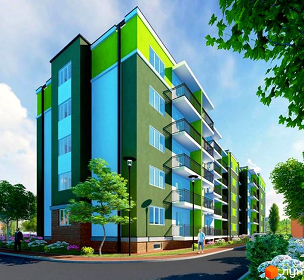 Клубний будинок „Васильків“ у зелених та блакитних тонах з білими балконами. Навколо будинку розташовані дерева, квіти та доглянута прибудинкова територія.