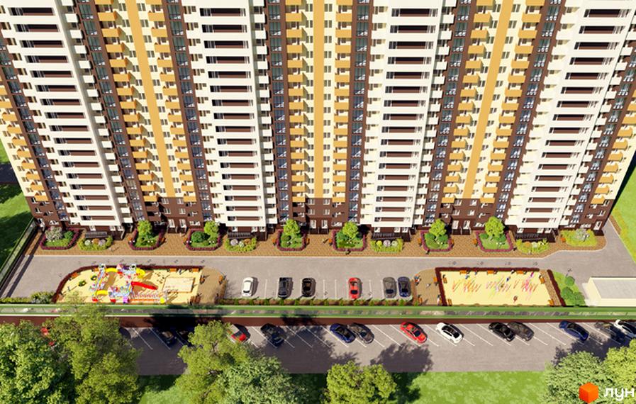 Висотна будівля ЖК Караваєві Дачі з фасадом у світлих тонах. На прибудинковій території розташовані парковка, дитячий майданчик та зелені насадження.