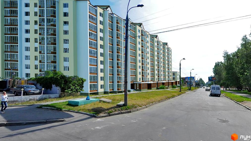 Зовнішній вигляд багатоповерхового будинку на вулиці Василя Порика. Навколо будинку розташована прибудинкова територія з дорогою та зеленими насадженнями.